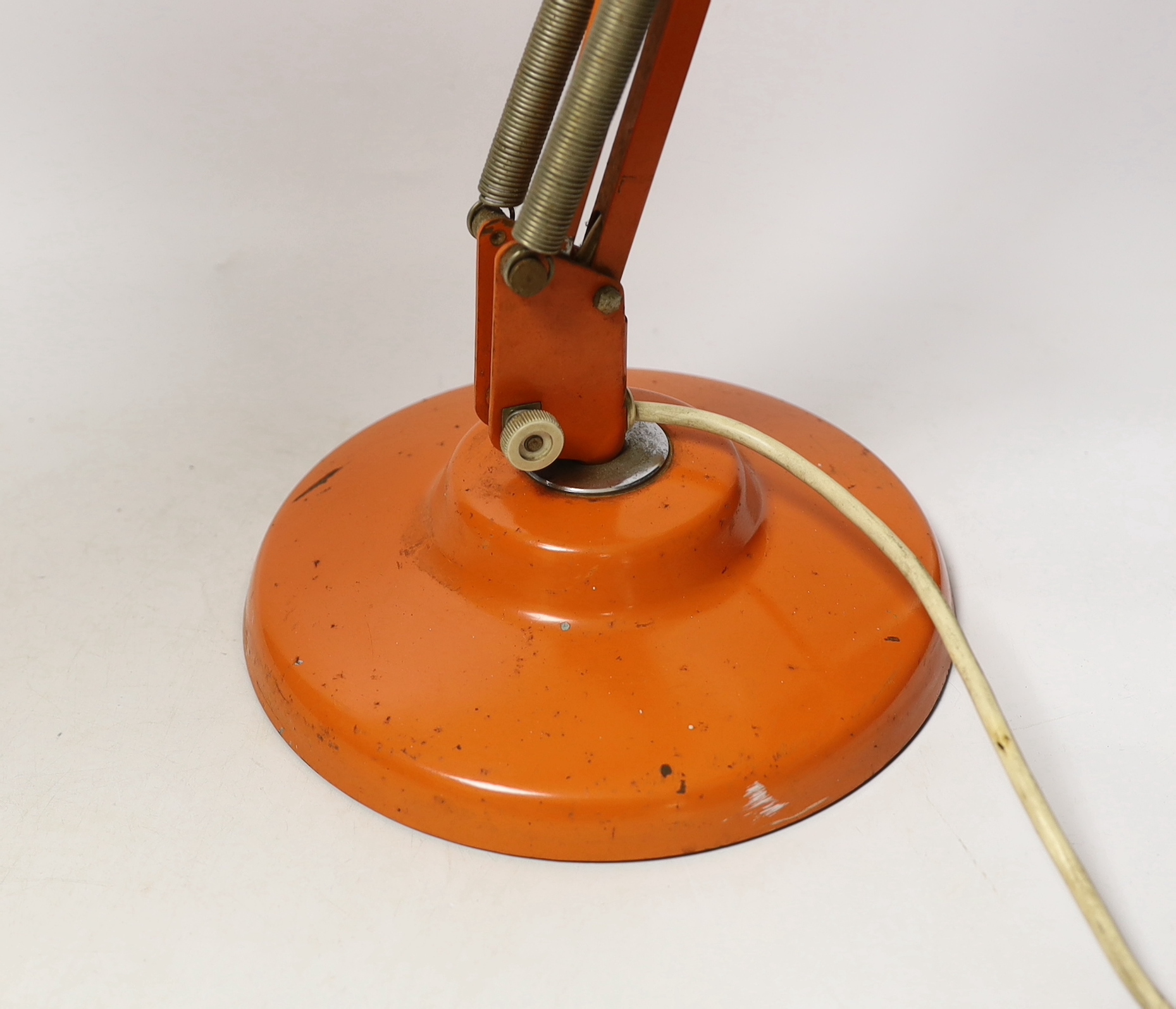 An orange Thousand and One Lamps Ltd angle poise lamp, approximately 76cm high